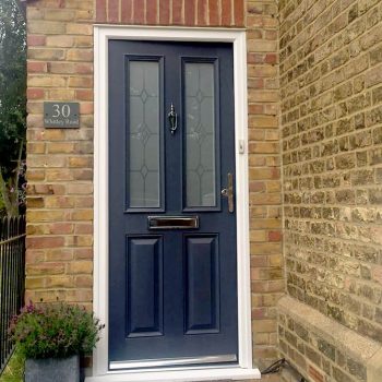 Grey composite door with silver handle and additional hardware