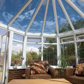 White uPVC victorian conservatory interior with a glass roof