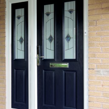 Black composite door with decorative glass and gold hardware