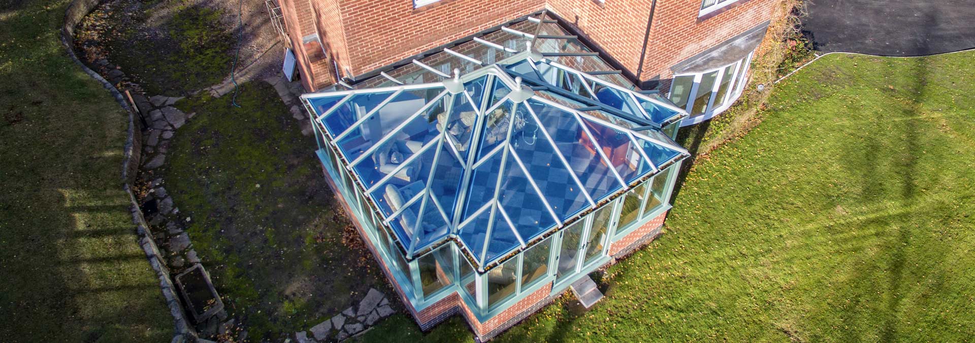 Large t-shape custom built conservatory with glass roof