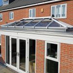 Red brick orangery installation with glass roof