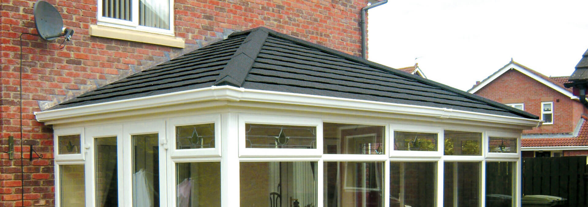 Large uPVC conservatory with grey tiled roof